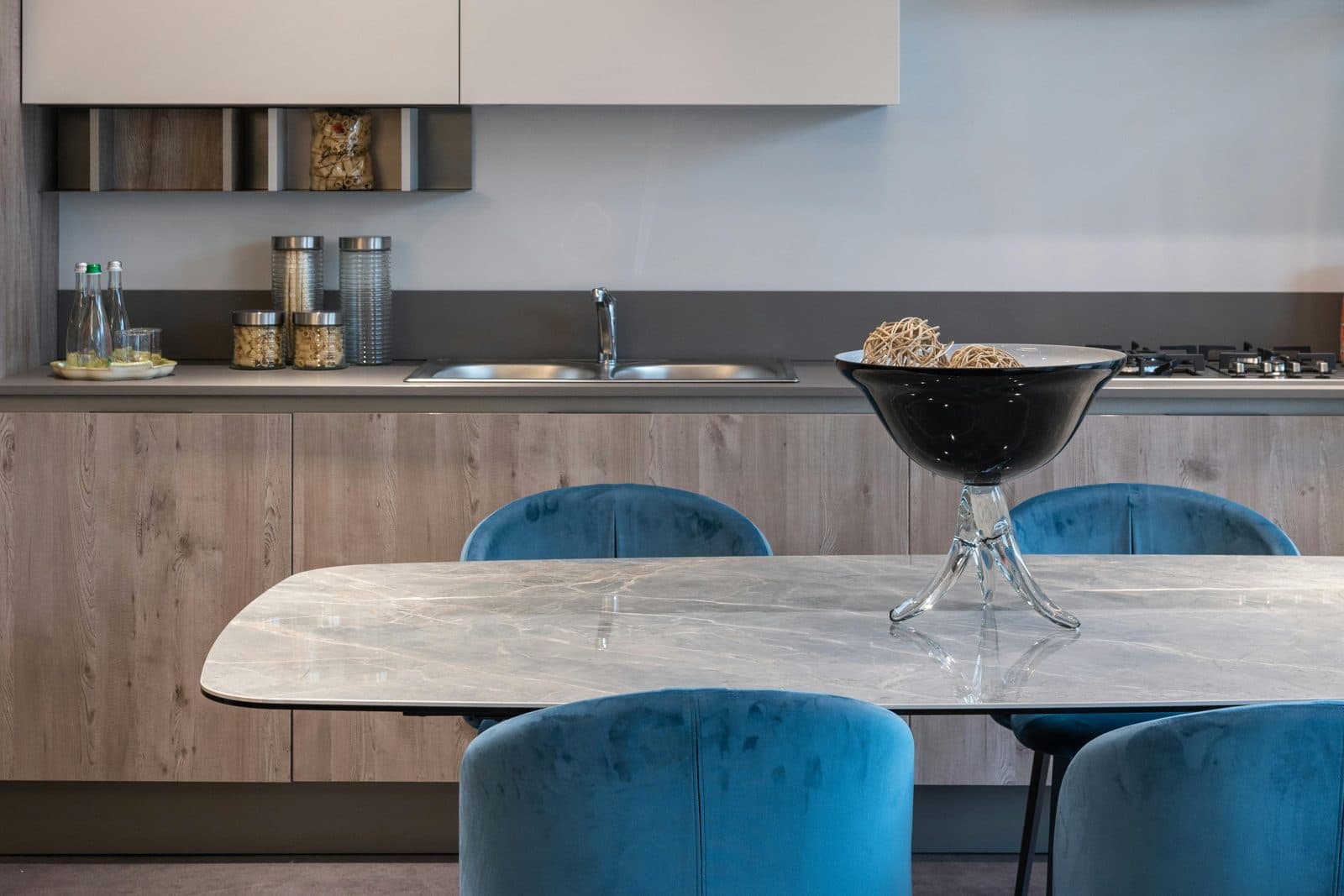 A furnished kitchen and dining area with a table and chairs